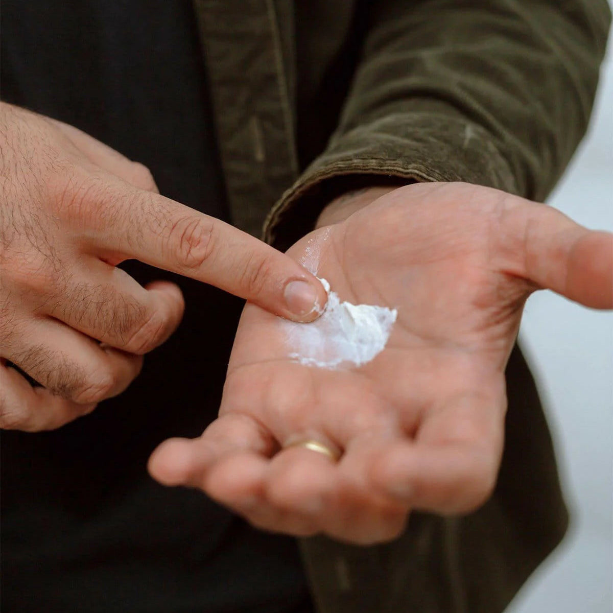 Person applying a small amount of Firsthand Supply Texturizing Paste to their palm
